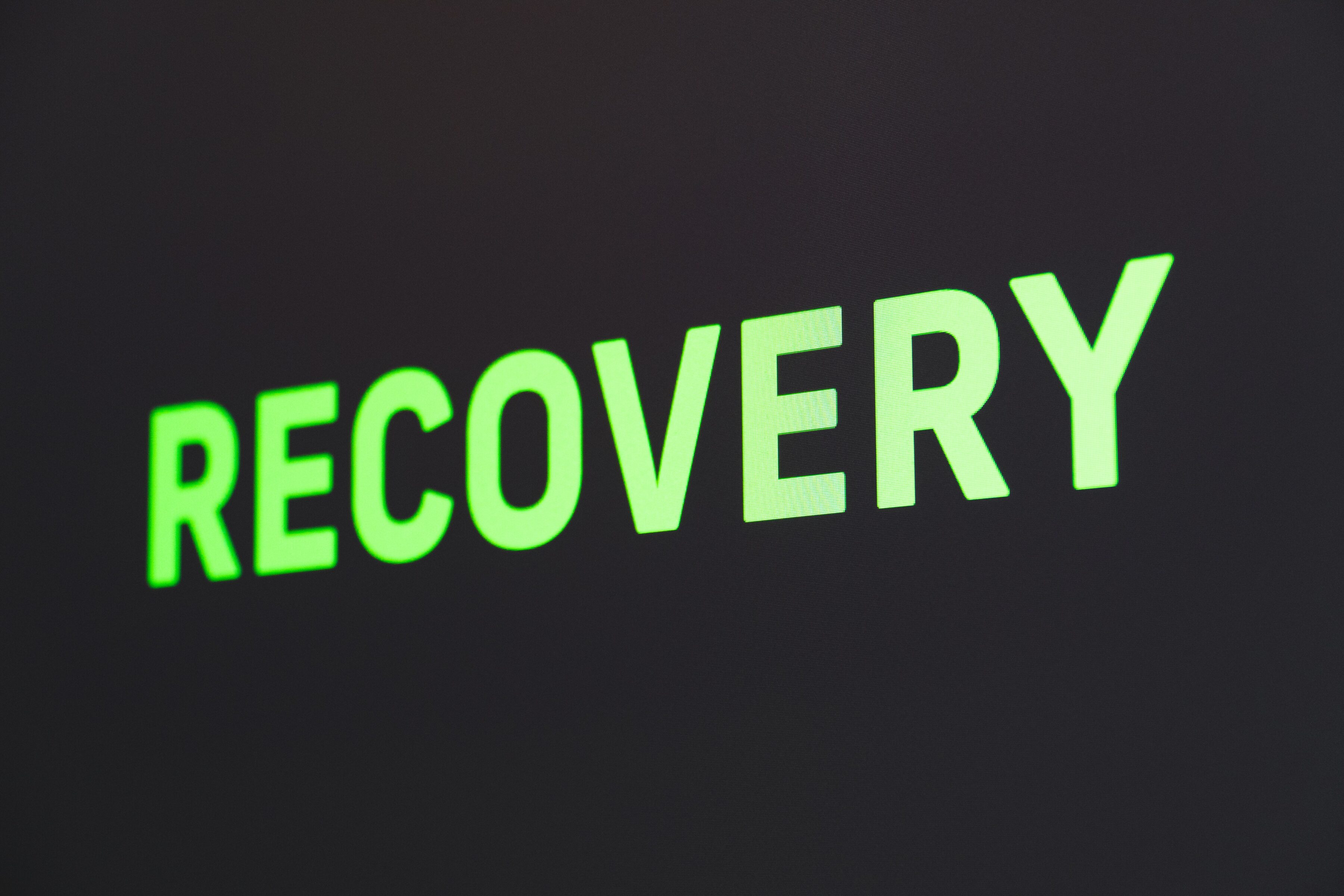 An image of the word recovery in green lettering on a black background.