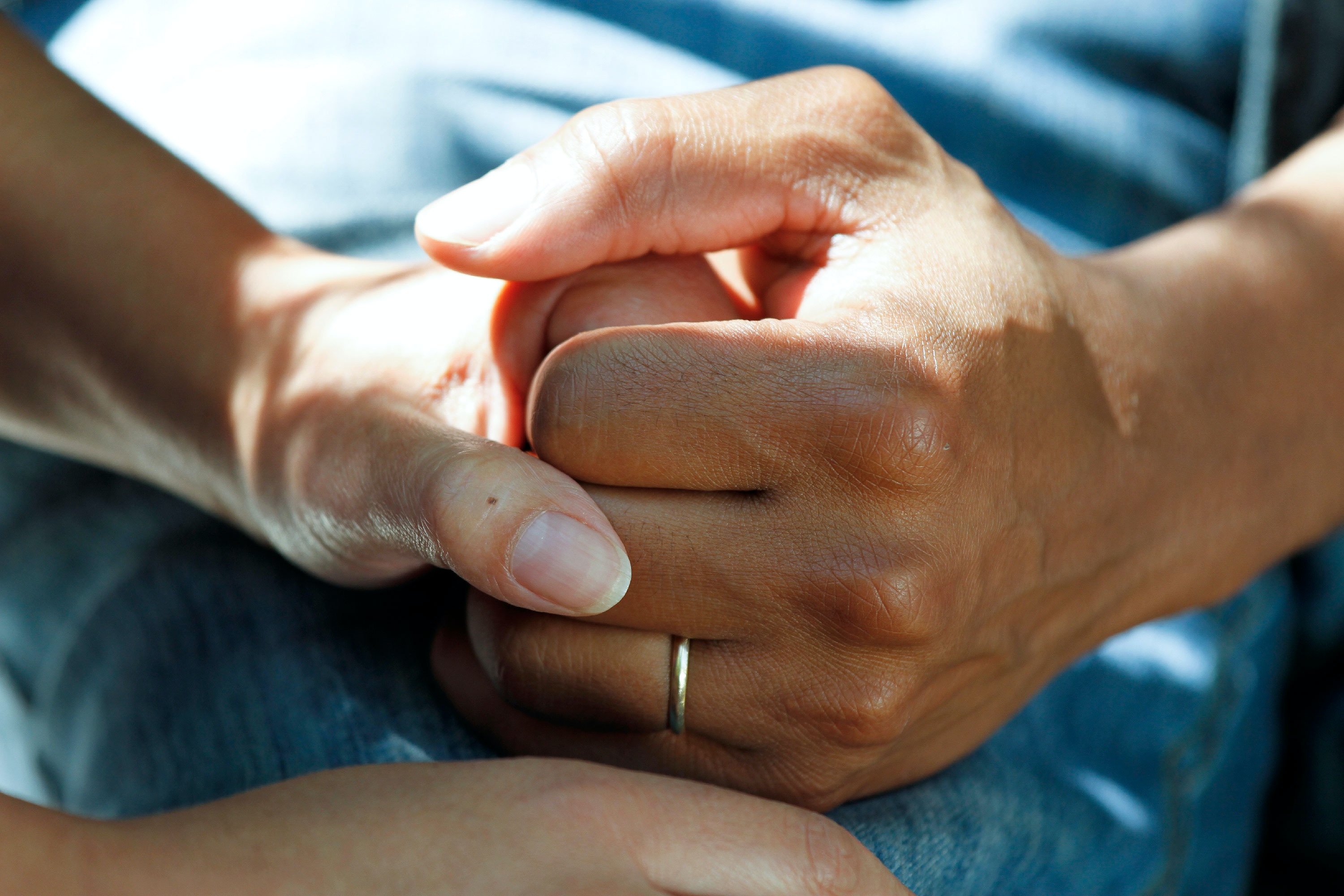 Hands held in social care setting.