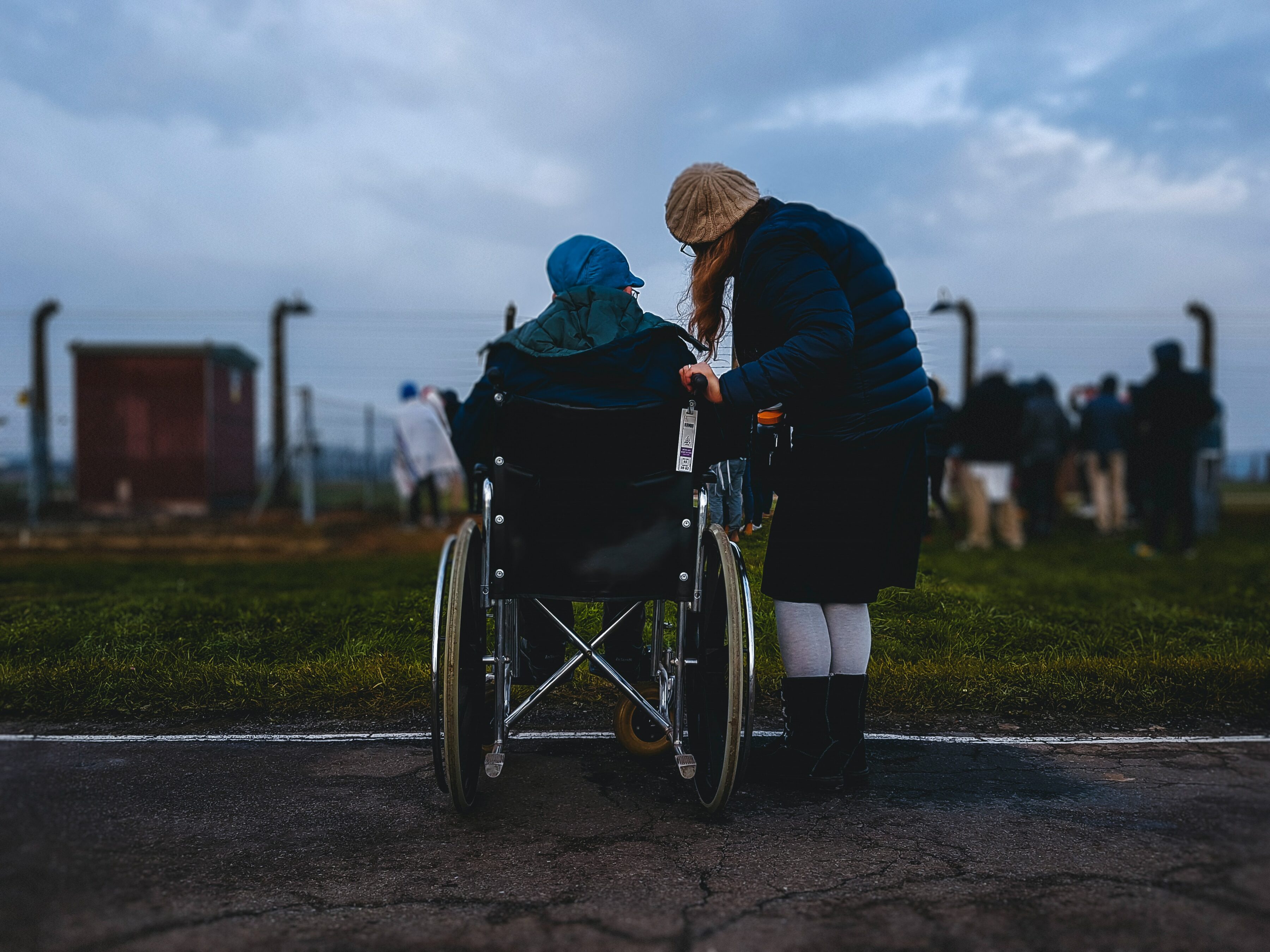 Wheelchair user being looked after by social care worker.